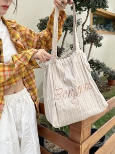 Striped canvas tote bag with Bonjour embroidery and drawstring closure for women