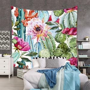 Detail of vibrant watercolor cactus and floral tapestry hanging in a modern bedroom