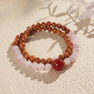 Detail shot of double-layered beaded bracelet with pink crystal and brown tiger eye stones