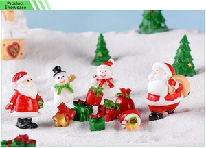 Miniature resin Christmas figurines featuring Santa and snowman in a snowy scene setup