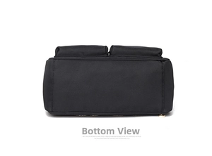 Macro detail of the reinforced bottom and sturdy stitching on the black nylon crossbody bag