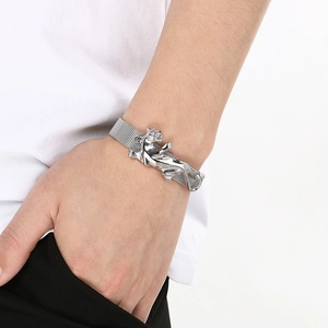 Detailed view of silver leopard sculpture on adjustable stainless steel mesh strap bracelet