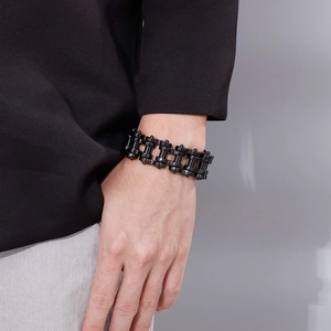 Detail of 22mm black stainless steel bike chain bracelet on a male wrist