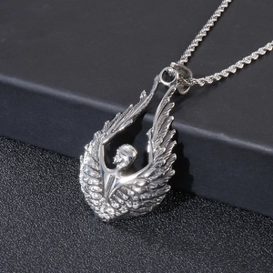 Detailed close-up of silver angel wings pendant with intricate feathers on a twisted chain