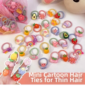 Macro detail of elastic mini fruit hair ties with colorful resin charms and mesh storage bag
