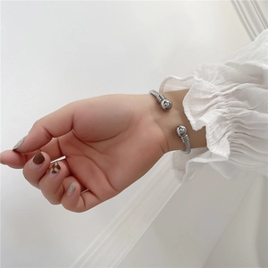 Close-up of a silver stainless steel cable twist bracelet with ball ends on wrist