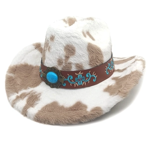 Detail of cow print cowboy hat with turquoise embroidered band and ethnic stone accent