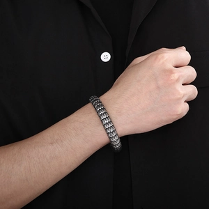 Close-up of retro silver dragon scale textured bracelet on a male model wrist