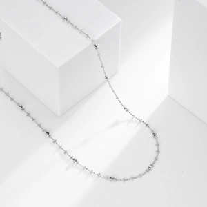Detailed close-up of S925 sterling silver geometric necklace with faceted beads on white background