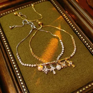 Adjustable zircon cross and pearl tennis bracelet set in gold and silver finish