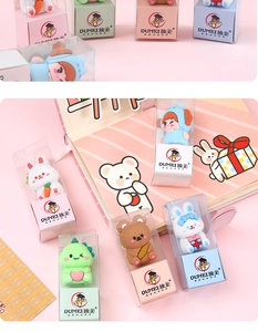Close-up of cute cartoon desk ornaments in transparent PVC packaging with pink base