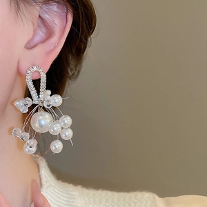 Close-up of pearl and crystal tassel earrings featuring delicate beaded fringe design