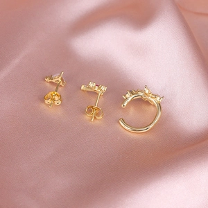 Detailed macro shot of S925 sterling silver stamp on gold earrings set with colored gems