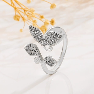 Macro shot of silver butterfly ring with cubic zirconia stones and leaf details