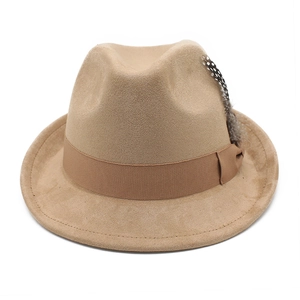Detail of khaki felt fedora hat featuring a brown ribbed band and spotted feather accent