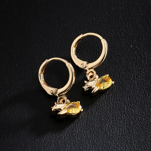 18K gold plated dinosaur earrings with yellow zircon gemstones on black leather