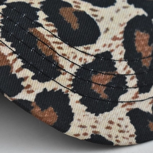 Close-up of leopard print baseball cap fabric with precise black stitching detail