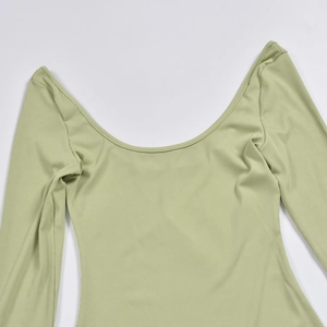 Close-up of grass green ribbed knit fabric featuring a deep U-neck and long sleeves