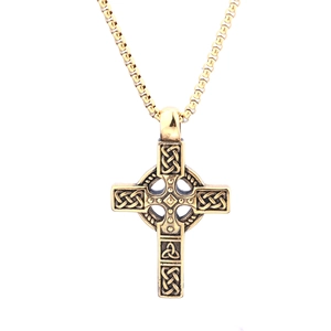 Vintage golden Celtic cross necklace with intricate knot patterns on a box chain
