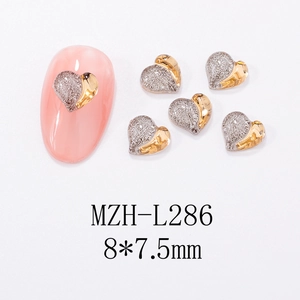 Detail of 8x7.5mm heart nail charms in silver micro-pave and gold mirror finish