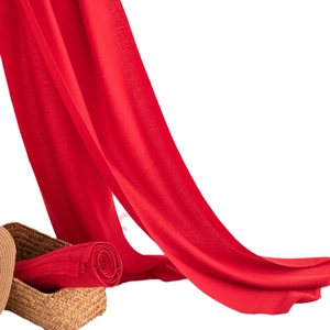 Elegant Chinese red long scarf shawl made of premium silk blend hanging on woven basket