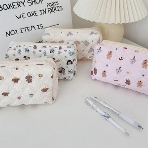 Detailed view of quilted stationery pouches with cute cartoon bear and dog prints
