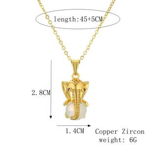 Detail view of gold elephant pendant with white stone inlay and product dimensions