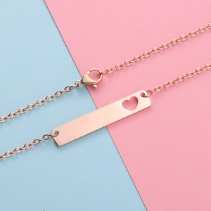 Detailed view of rose gold bar necklace featuring a heart cutout and lobster clasp