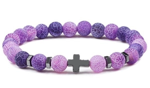 Detailed macro shot of purple dragon vein agate beads with a black metal cross charm