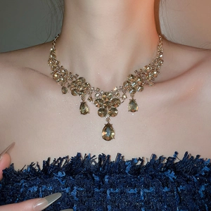 Close-up of sparkling flower drop necklace with amber crystals on a model's neck