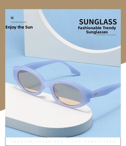 Detail of lavender cat eye sunglasses with gray gradient lenses on geometric stands