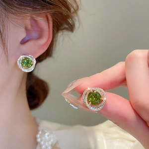 Elegant vintage gold earrings featuring a green zircon stone with sparkling diamond accents
