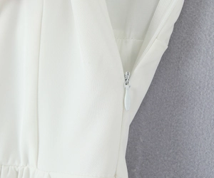 Detailed close-up showing the invisible zipper and fine twill fabric of the white dress