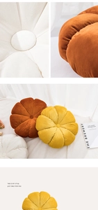 Macro detail of pumpkin velvet cushion with radial stitching and central button