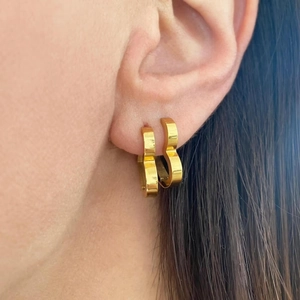 Elegantly worn gold heart-shaped hoop earrings made of 18k gold plated stainless steel