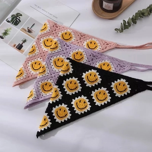 Macro detail of three handmade crochet bandanas with cheerful sunflower patterns