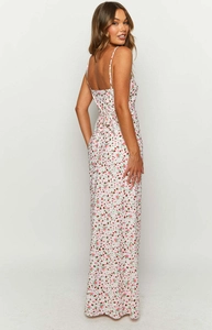 Close-up of white floral maxi dress with pink flower patterns and thin straps detail