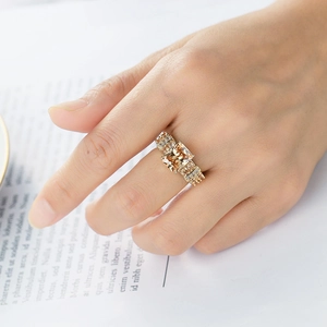 Detail of champagne gold ring with square emerald-cut stone and micro-pave zircons