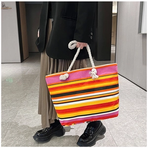 Detailed view of colorful striped canvas tote with white cotton rope handles and large capacity