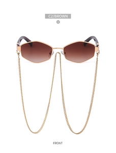 Close-up of golden hexagonal sunglasses with gradient brown lenses and long gold chain