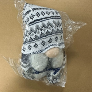 Detail of wool gnome doll with knitted hat in transparent plastic shipping bag