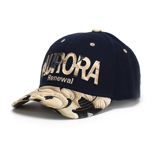 Detail of navy baseball cap with gold Aurora Renewal embroidery and floral pattern