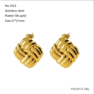 Detailed macro view of gold plated 18K stainless steel square woven knot earrings
