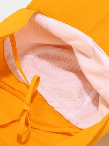 Detail of breathable white mesh lining and adjustable drawstring on yellow sun hat