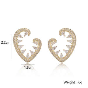 Elegant gold heart earrings with white zircon and pear-cut crystals on a white background