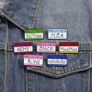 Set of 7 colorful enamel letter pins with K-Pop fandom names on blue denim jacket