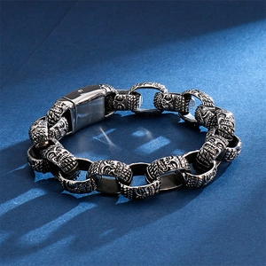 Macro view of silver punk skull chain links and square clasp on a stainless steel bracelet