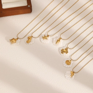 Golden ocean series necklaces featuring sea turtle, starfish and shells on warm background