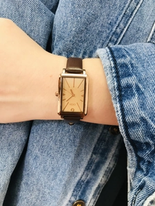 Close-up of GEDI rectangular quartz watch with brown leather strap worn on wrist