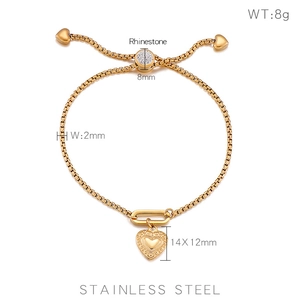 Detail of adjustable golden stainless steel heart bracelet with crystal slider bead